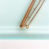 Picture of Edwardian Era Pair Of 14K Yellow Gold, Seed Pearl & White Enamel Bar Brooches