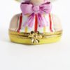Picture of  Retired Limoges Porcelain Vacationing Lady Trinket Box with Surprise Palm Tree Inside. 