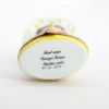 Picture of  Retired Limoges Porcelain Vacationing Lady Trinket Box with Surprise Palm Tree Inside. 